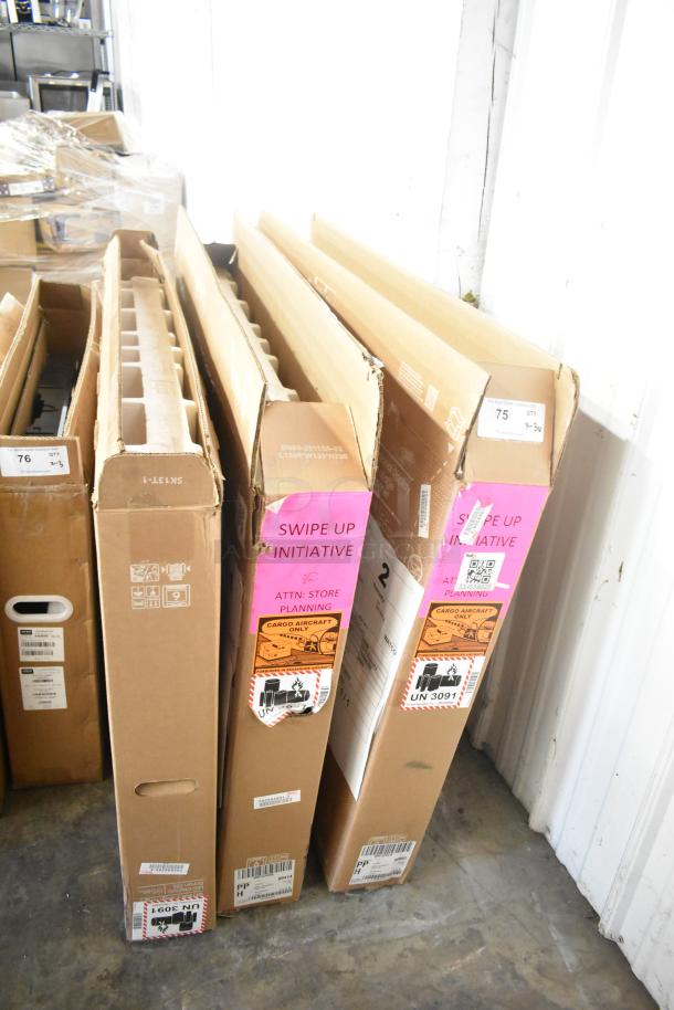 Three Samsung QM55C 55" TVs in original boxes. Boxes labeled "Swipe Up Initiative" and "Cargo Aircraft Only." Buyer pickup needed.