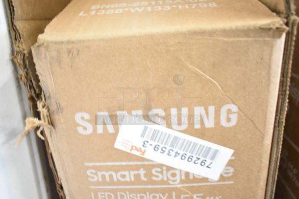 Samsung QM55C 55" TVs in original box, labeled "Smart Signage". Box shows slight wear; pick-up required, no shipping.