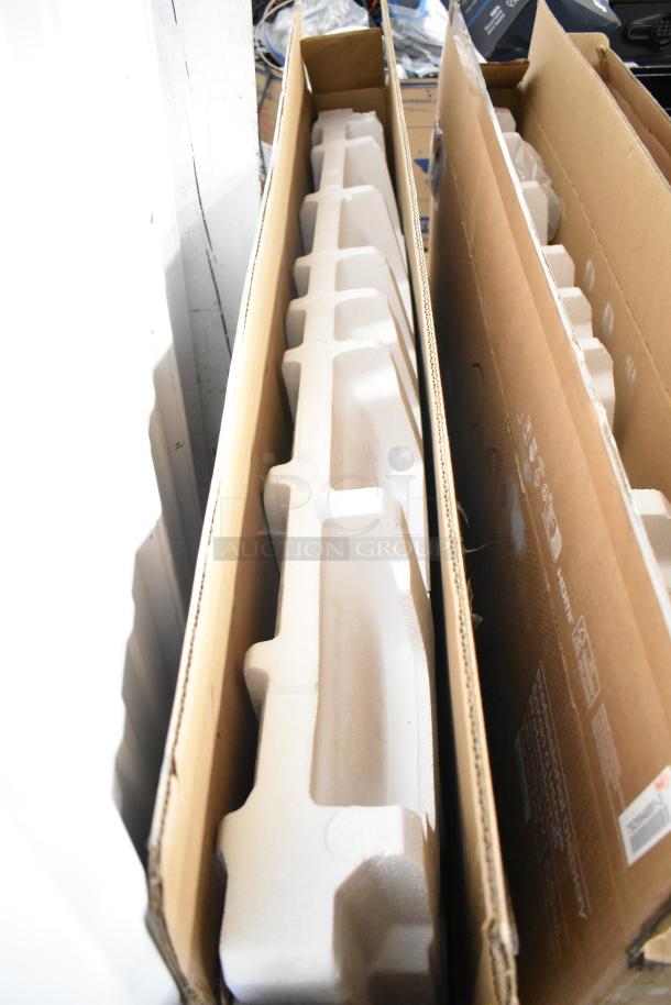 Three Samsung QM55C 55" TVs in original boxes, new condition. Buyer pickup required. Auction offers three times bid.