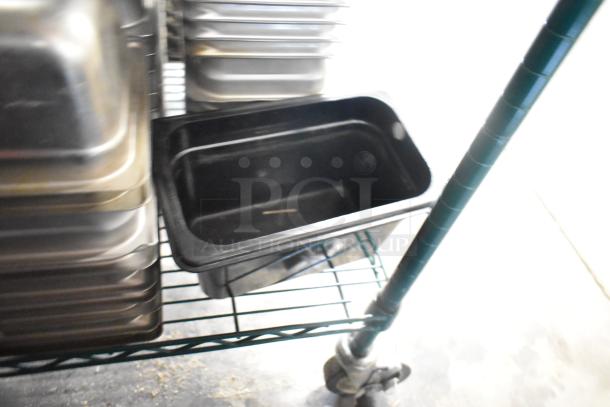 64 stainless steel drop-in bins, including 1/3 size, on a rack. Suitable for kitchen use, new condition.