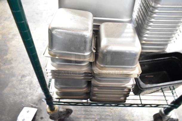 64 stainless steel drop-in bins, including 1/3 size, stacked on a rack, fine condition. 64 times your bid offer.