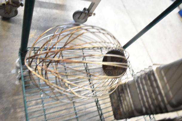 Auction lot with 62 items: whisk attachment for a mixer and 61 stainless steel drop-in bins, 1/6 size, on a wire cart.