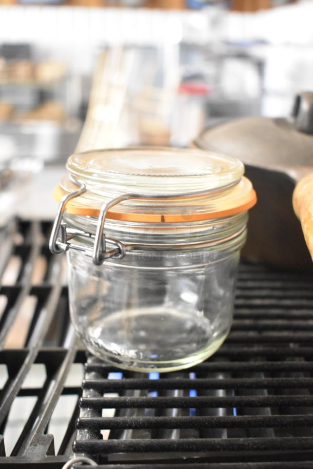 Glass jar with metal clasp and orange seal, perfect condition, part of a lot of 6 various auction items.