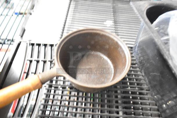 Six various items including a cast iron pan, jar, blade sharpener, and bin. Good condition, 6 times your bid.