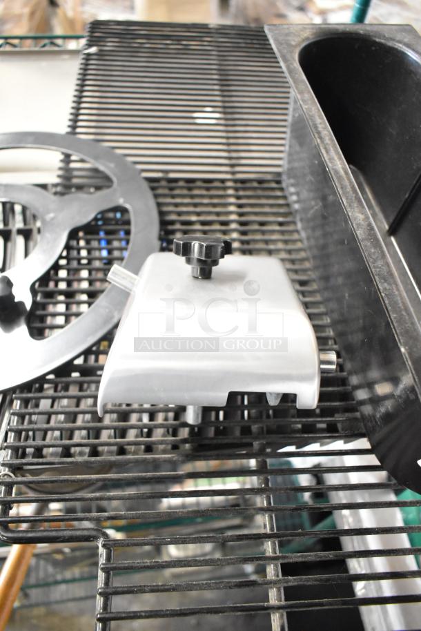 Assorted lot of six items including a metal blade sharpener, circular vent cover, and black plastic bin on metal rack.