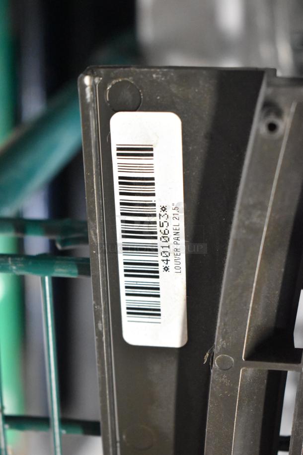 Close-up of a louver panel with a barcode label indicating "Louver Panel 21.5" among a lot of 6 various items.