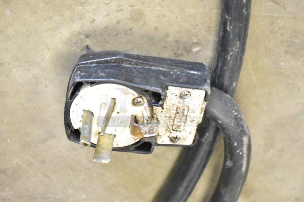 Close-up image of the plug for a 2016 Turbochef HhC2020 commercial conveyor oven. Shows wear and metal prongs.