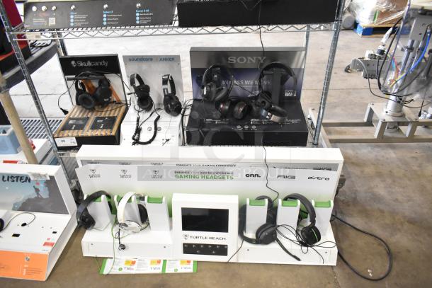 Four headphone display units featuring Skullcandy, Soundcore Anker, Sony, and Turtle Beach brands on shelving.