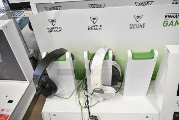 Turtle Beach headphone display stands with various headphones, some wear visible. Includes bid multiplier offer.