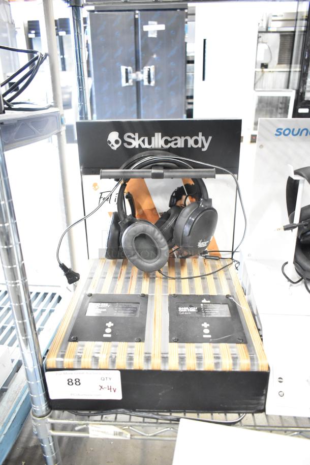 Skullcandy headphones display, includes headphones on a branded stand, quantity tag showing 4 times your bid.