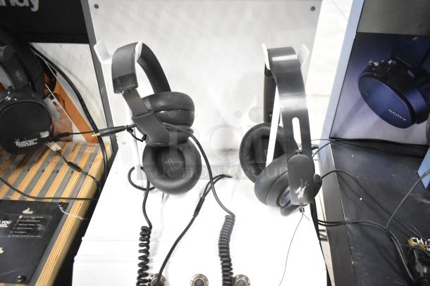 Four headphone displays, including Skullcandy and Sony models. Condition: good, visible brands on packaging.