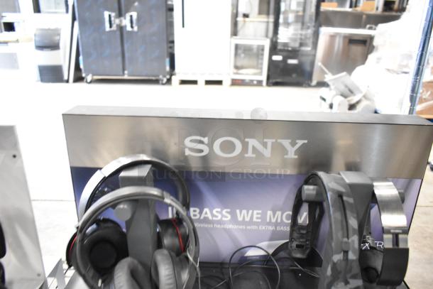 Sony headphones display featuring multiple models, showcasing styles and detail. Excellent condition with visible branding.