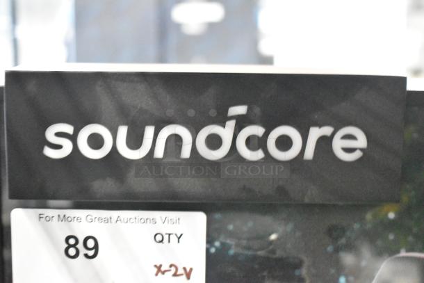 Two store display signs featuring Soundcore and Sony speakers, clear branding, quantity tag reading "89, X2V".