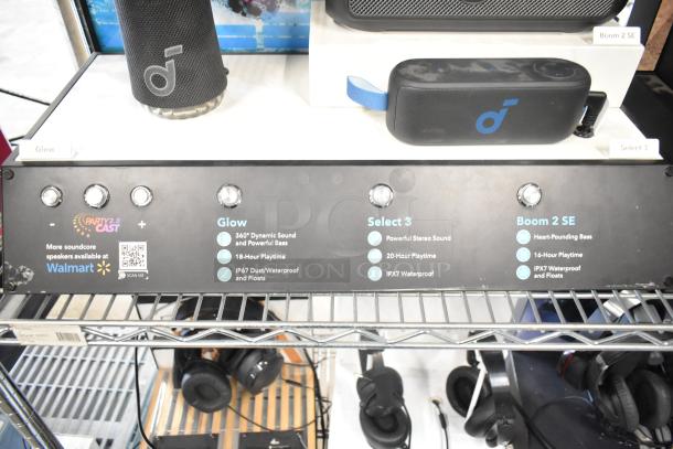 Store displays featuring Soundcore Glow and Select 3 speakers, highlighting features like dynamic sound, waterproofing, and playtime duration.