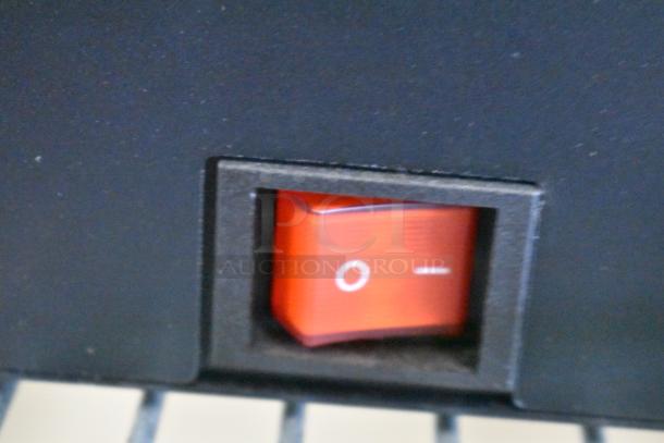 Close-up of a red power switch on a speaker display unit, indicating on and off positions.