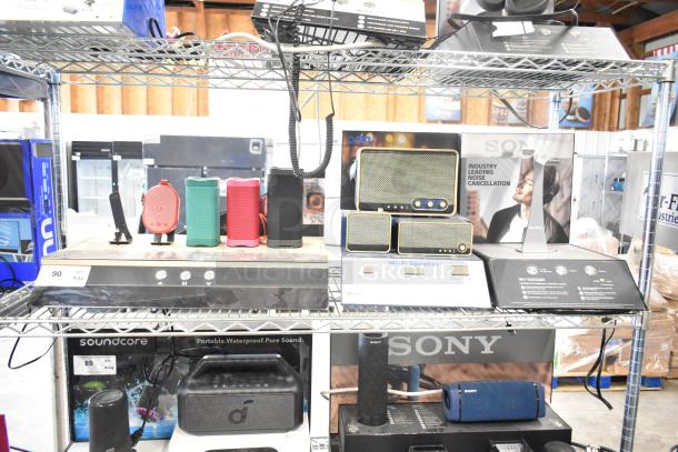 3 store display items featuring Sony headphones, Skull Candy speakers, and an Onn speaker on shelving unit.