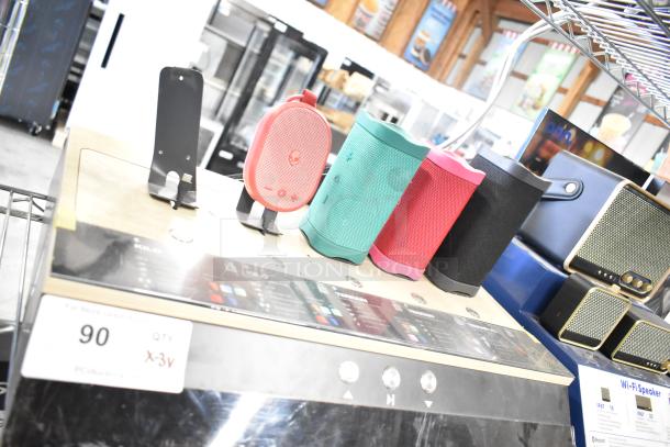 Store displays with Sony headphones, Skull Candy and Onn speakers showcased on a wooden platform. Tags indicate price details.