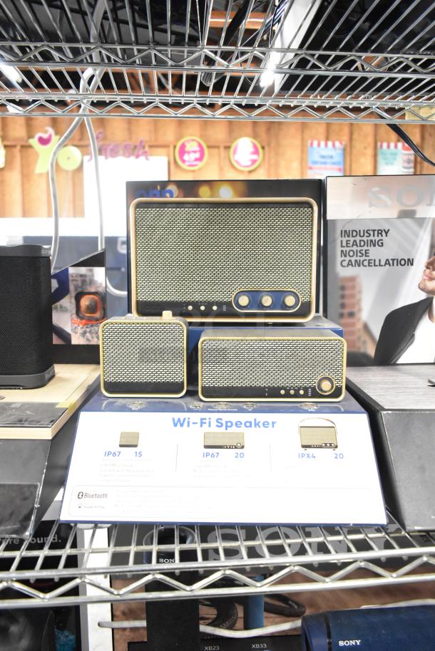 Three store displays featuring Sony headphones, Skull Candy speakers, and Onn speaker; "Industry Leading Noise Cancellation" sign visible.