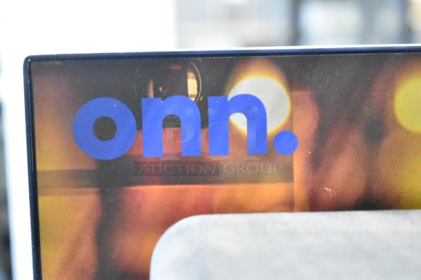 Store display featuring Onn logo; auction includes Sony headphones, Skull Candy and Onn speakers.