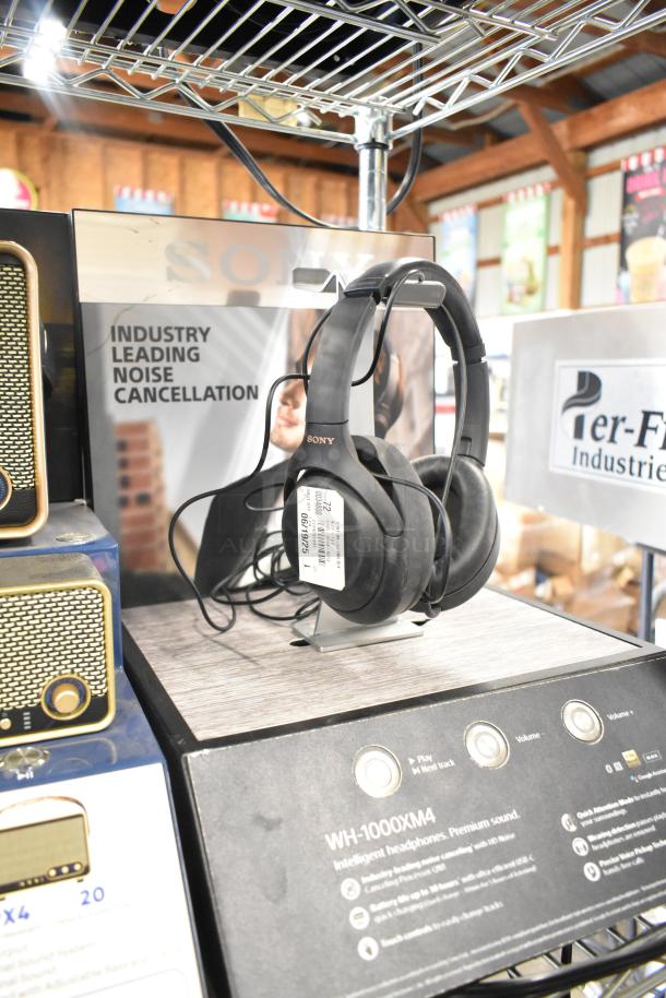 Sony WH-1000XM4 headphones display, featuring noise cancellation. Includes Skull Candy and Onn speaker displays.