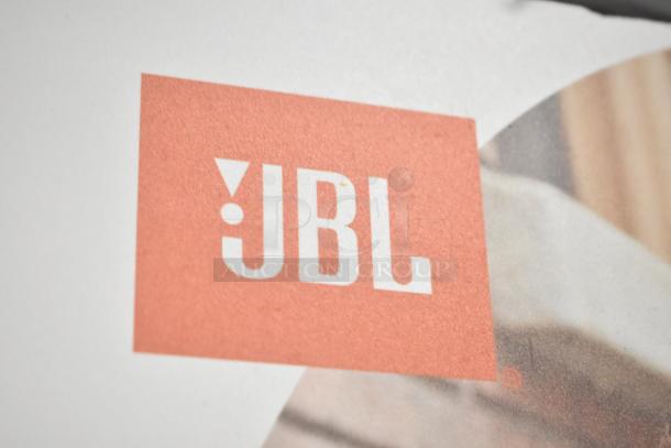 JBL logo on store display for JBL headphones, part of a set including Sony headphones and Onn speakers.