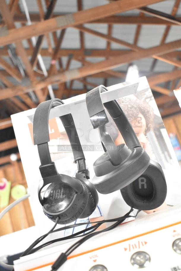 Three store display items featuring Sony headphones, JBL headphones, and Onn speakers, in good condition.