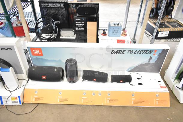 Three store displays featuring TonieBox, JBL speakers, and Altec speakers. Display includes promotional signage.