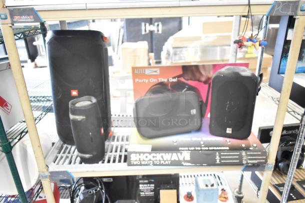 Three speakers, two JBL and one Altec, displayed on a shelf. Altec box reads "Party On The Go." Mixed condition.