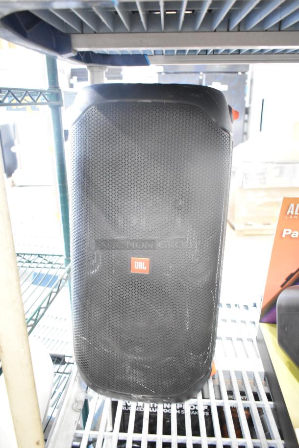 Three speakers on display: two JBL and one Altec, featuring robust design. Visible JBL logo on the front grille. 