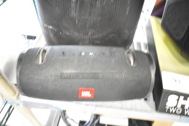 Three speakers, including two JBL models and one Altec, with textured surfaces. Visible JBL logo. Condition: used.