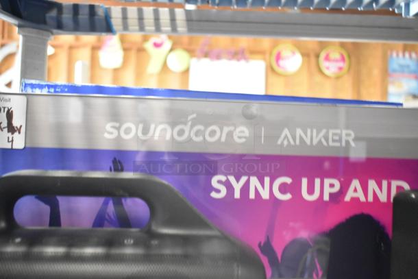 Anker Soundcore speaker store display, black with visible branding and promotional text, good condition.