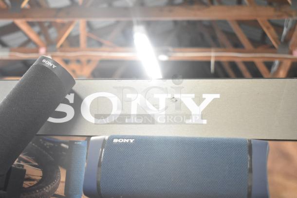 Four store displays featuring a Sony speaker. Includes TonieBox 1, Anker Soundcore, and Onn speaker. Mixed condition.