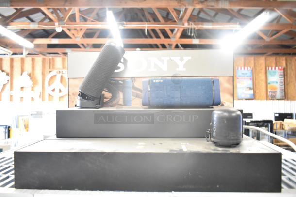 4 store display speakers including a TonieBox, Anker Soundcore, Onn, and Sony speaker, in used condition.