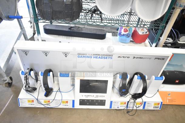 Store display with TonieBox 2s, Turtle Beach headphones, and Sonos sound bar. Includes various headset brands and product pricing.