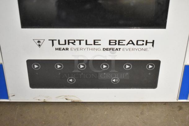 Store display featuring Turtle Beach branding and control panel with play and volume buttons, slight wear visible.
