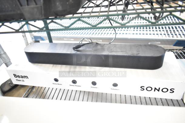 Sonos Beam Gen 2 sound bar on display box featuring demo buttons. Condition appears good, used for in-store display.