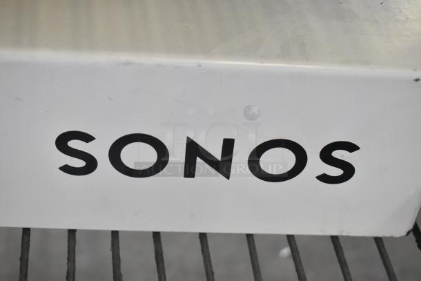 Store display of Sonos Sound Bar with visible logo, showcasing audio quality and modern design.