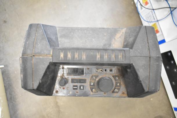 Monster Mini Rockin Roller speaker in used condition with visible wear on controls and handle.