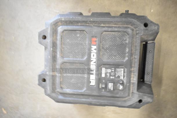 Monster Mini Rockin Roller speaker, slightly worn, visible brand logo and controls, durable black case.