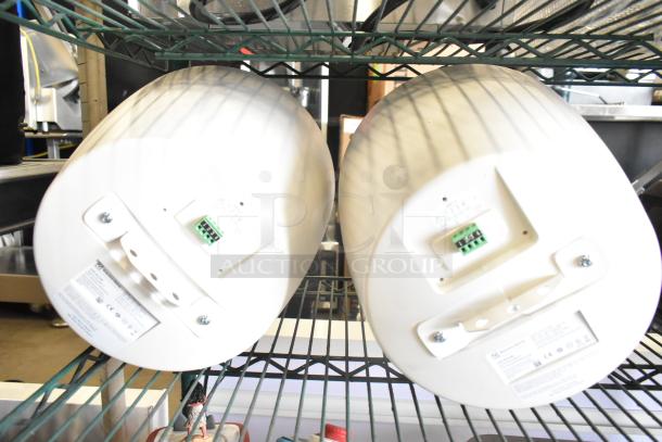 2 Electro-Voice EVID-P6.2UW speakers on shelves, with connection terminals and product labels visible.