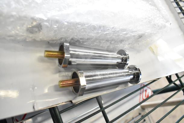 Metal components in bubble wrap, possibly parts for an Avantco 184T140 commercial conveyor toaster. New condition.