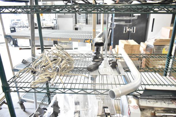 Lot of various items including metal handle, Motorola walkie talkie, barcode scanner, stand, wiring on metal shelf.