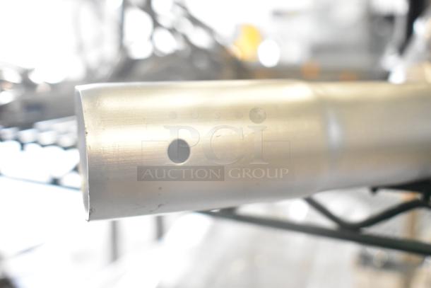 Metal handle from auction lot featuring a Motorola walkie talkie, barcode scanner, and stand. Appears in good condition.