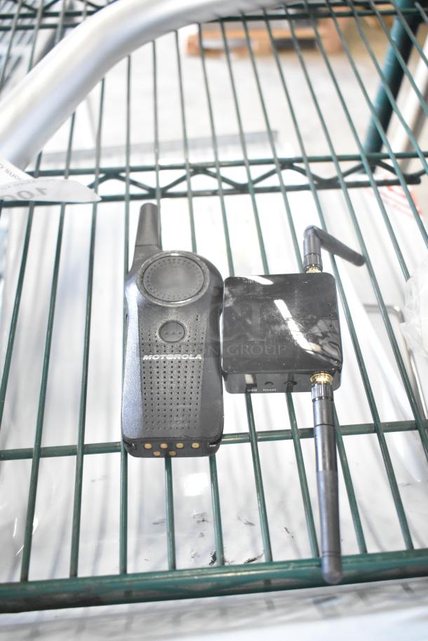 Lot of items including a Motorola walkie talkie, metal handle, barcode scanner, and stand. Good condition, no tags visible.