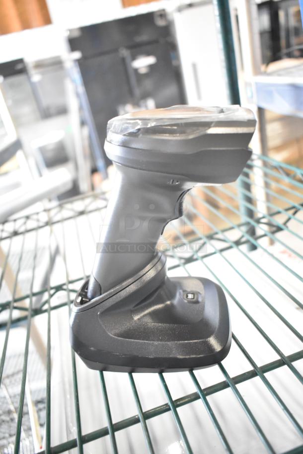 Barcode scanner on a stand, part of a lot including a metal handle and Motorola Walkie Talkie. Good condition.