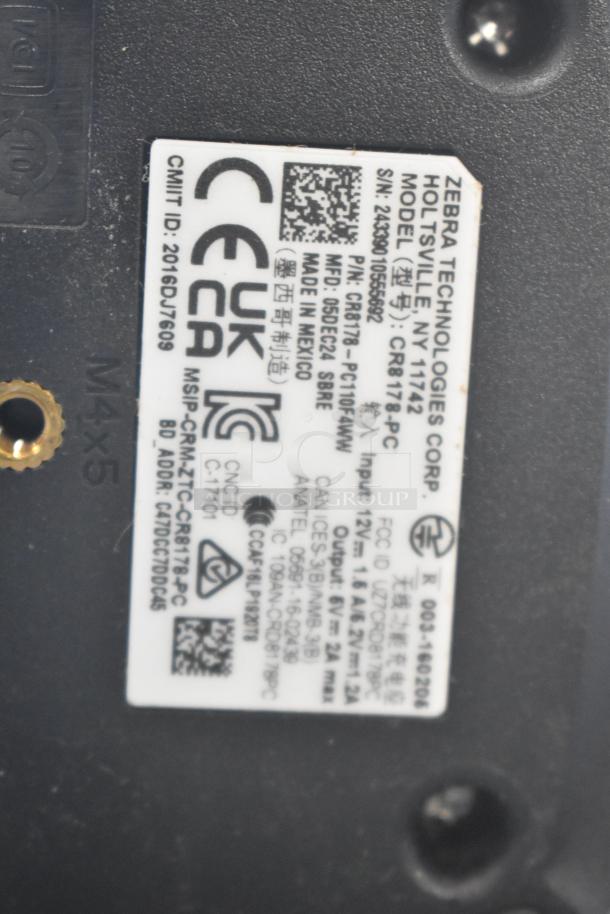 Zebra Technologies label, model CR8178-PC, showing serial and regulatory info. Used in auction lot with walkie talkie, scanner.