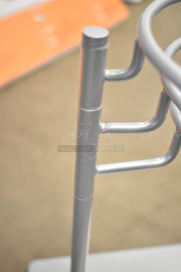 Metal stand handle, silver finish, part of an auction lot with various items including a Motorola walkie-talkie.