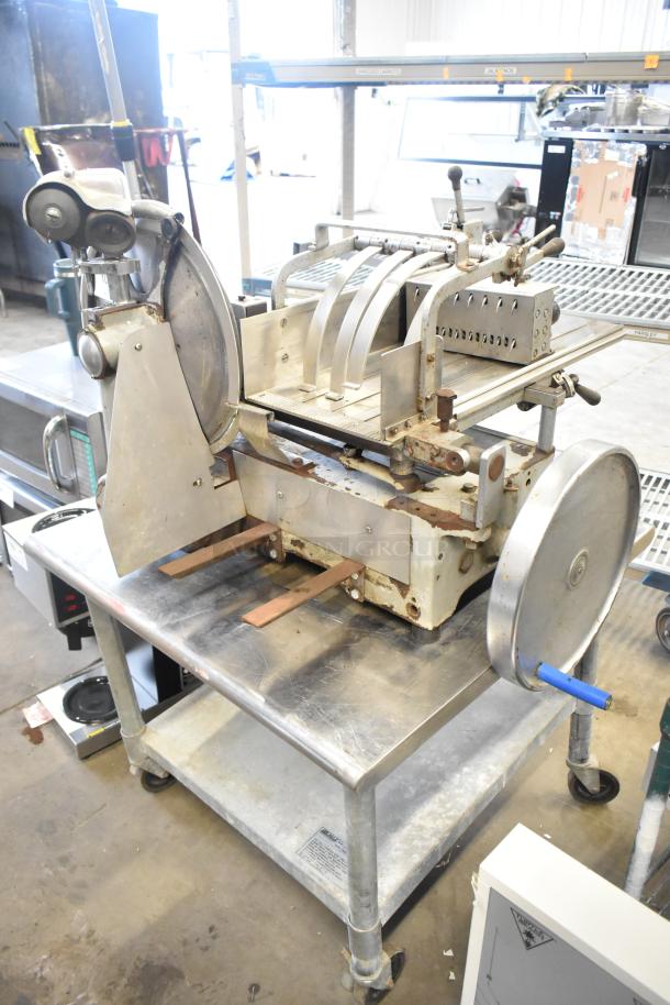 US Berkel commercial countertop flywheel meat slicer on equipment stand, showcasing metal components and visible signs of use.