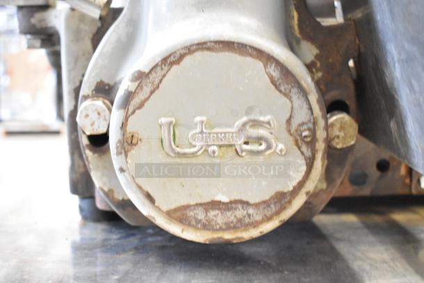 US Berkel commercial countertop flywheel meat slicer on equipment stand, showing manufacturer branding and used condition.