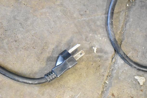 Close-up of a power cord with a two-prong plug, associated with the 2022 Bunn VPR Coffee Machine.